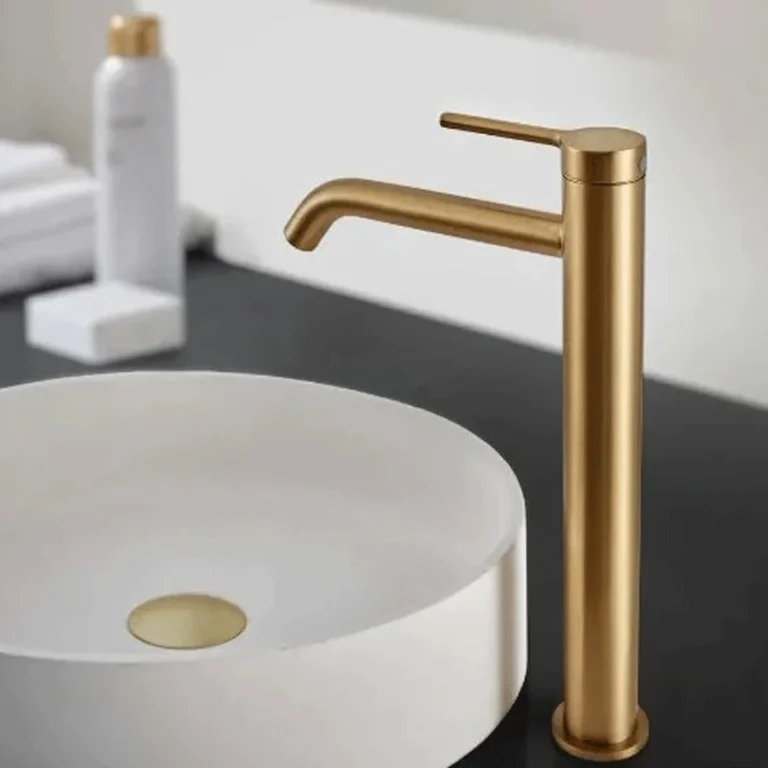 Grifo de lavabo monomando alto Turín, en dorado sobre lavabo blanco