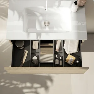 Mueble de baño Esencial con lavabo porcelánico, con cajón abierto en madera