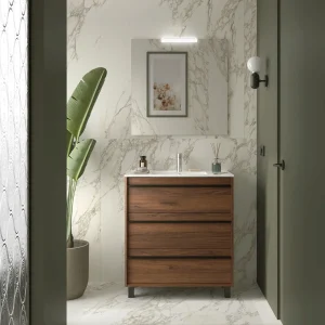 Mueble de baño Attila con 3 cajones y patas a suelo con gran capacidad, en madera oscura, ambientado en baño