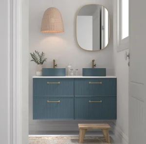 Mueble de baño suspendido o con patas de cuatro cajones con encimera para lavabos, en azul, ambientado en baño