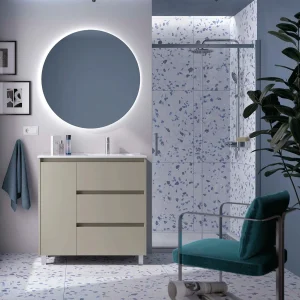 Mueble de baño Noja con 3 cajones, 1 puerta, lavabo desplazado y patas cromadas, en beige, ambientado en baño