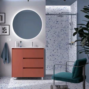 Mueble de baño Noja con 3 cajones, 1 puerta, lavabo desplazado y patas cromadas, en terracota con espejo redondo