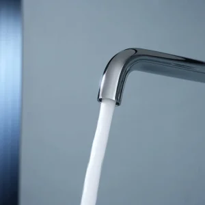 Grifo de lavabo empotrado monomando serie Bless de Imex, con agua saliendo del caño en cromo